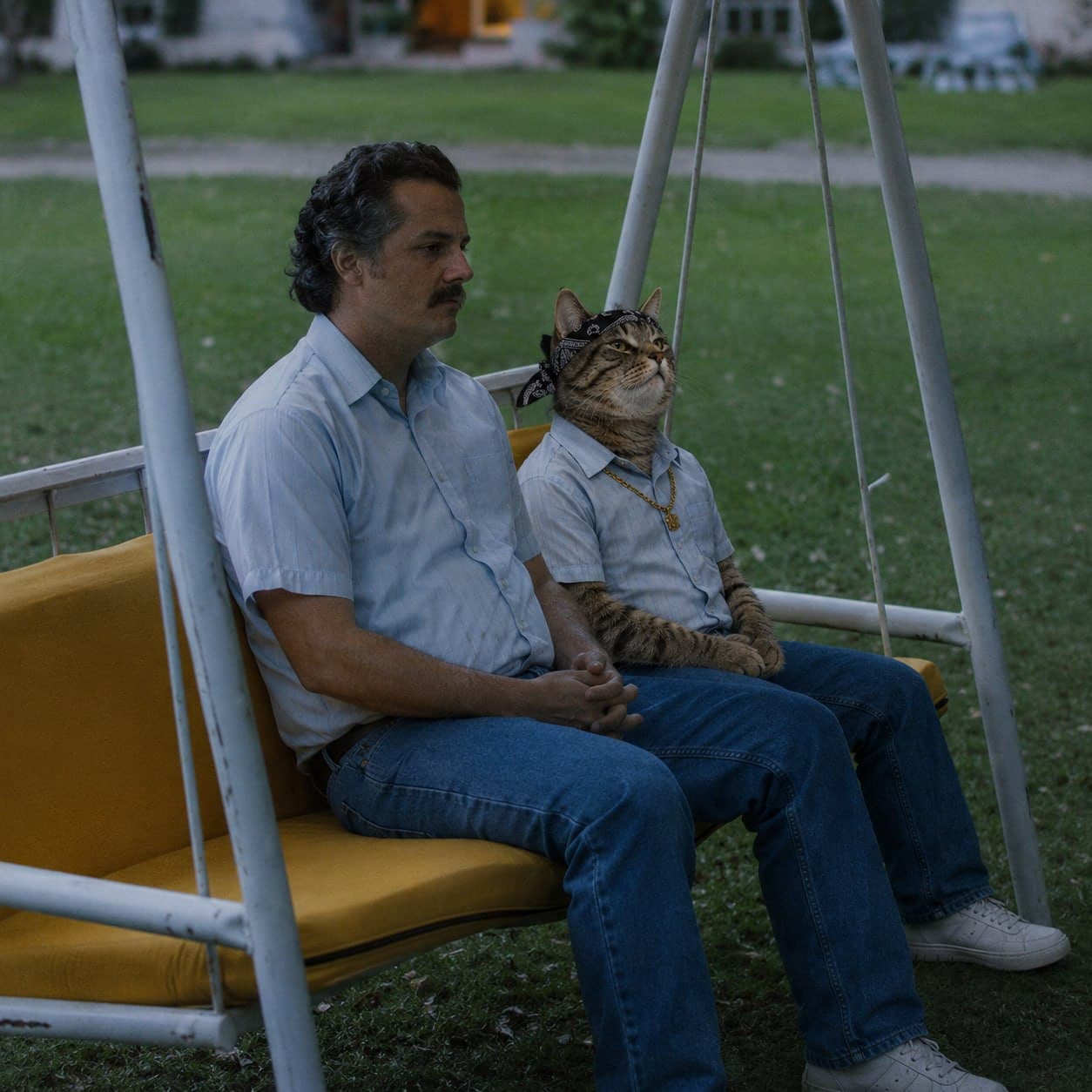 REAL sitting on a porch swing next to an associate.